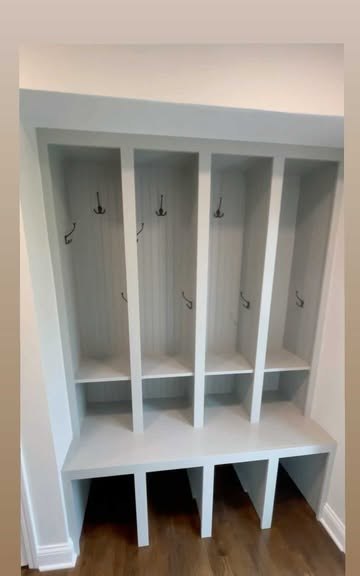 Wood floor under the painted lockers in a mudroom David built.